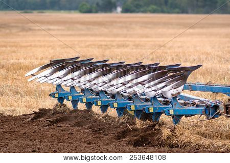 A Tractor With A Plow Treats The Soil.