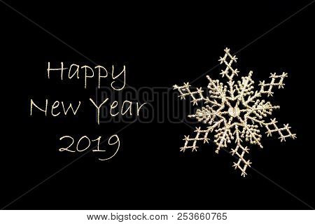 Golden Christmas Snowflake Close-up On Black Background. Xmas Decoration. With The Inscription Happy