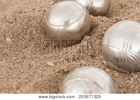 Beach. A Game Of Bocha. Brilliant Silver Balls For A Bocha On The Sand.