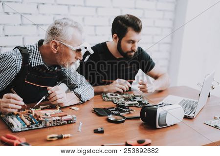 Two Men Repairing Hardware Equipment From Pc. Repair Shop. Worker With Tools. Computer Hardware. You