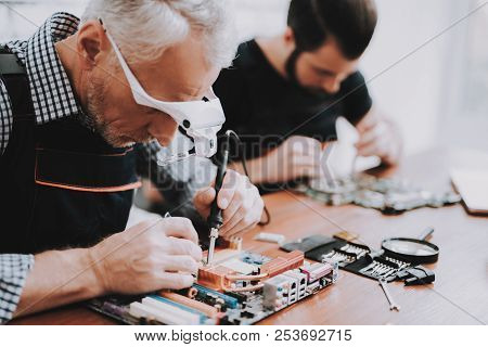 Two Men Repairing Hardware Equipment From Pc. Repair Shop. Worker With Tools. Computer Hardware. You