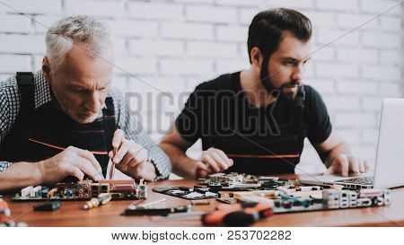 Two Men Repairing Hardware Equipment From Pc. Repair Shop. Worker With Tools. Computer Hardware. You
