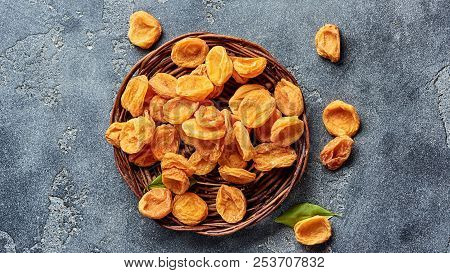 Dried Apricots On Gray Concrete Background With Copy Space. Top View.