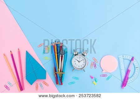 Back To School Styled Flat Lay Scene With Multicolored School Supplies With Paper Plane On Pink And 