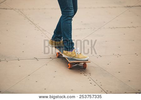 One Woman Skateboarder Sakteboarding On Skatepark Ramp