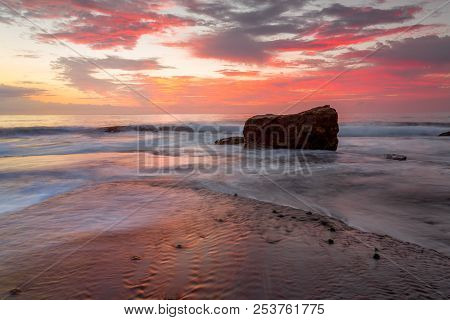 Tidal Ocean Flows With Sunrise Colours And Reflections On Turimetta Reef.  Australia
