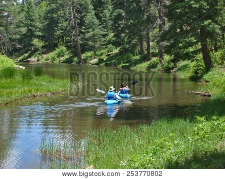 A Couple In Blue Kayaks Paddling On Woods Canyon Lake On The Mogollon Rim East Of Payson In Arizona.