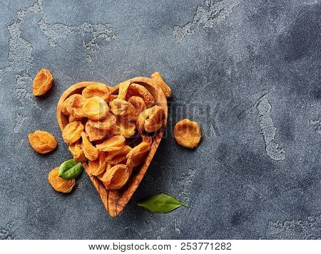Dried Apricots On Gray Concrete Background With Copy Space. Top View.