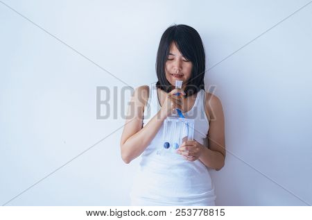 Patient Asian Woman Using Incentive Spirometer Or Three Balls For Stimulate Lung On White Blackgroun