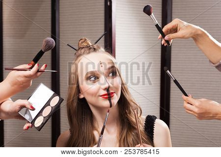Beautiful Young Joyful Model With Professional Unusual Makeup And A Coiffure With Topknot And Braid 
