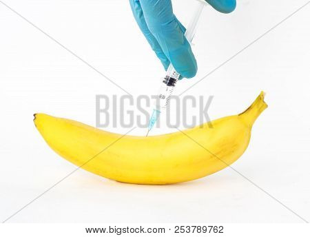 Banana On A White Background In Which Gmo And Nitrates Are Injected, Close-up, Genetically Modified 