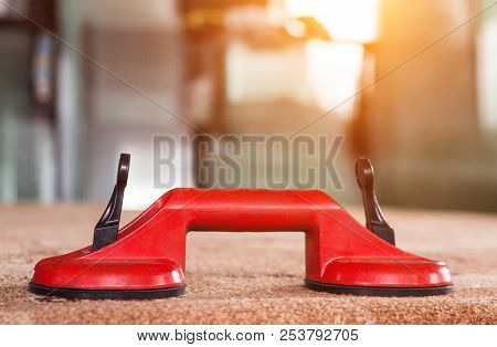 Red Suction Cup For Glasses On The Background Of Double-glazed Windows, Production Of Pvc Windows