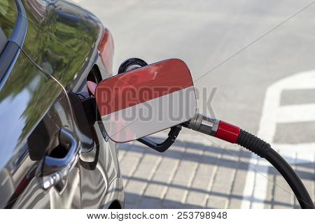 Fueling Car With Petrol Pump At A Gas Station.