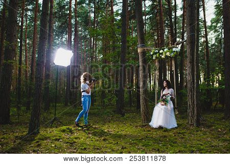 Professional Wedding Photographer Using Strobe And Softbox To Make Pictures