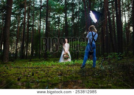 Professional Wedding Photographer Using Strobe And Softbox To Make Pictures
