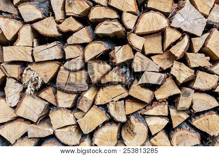 Firewood Stack Wall. Stack Of Wood Prepared For Winter And Cold Weather. Dry Chopped Oak Wood. Woode
