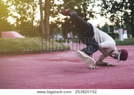 Young Hip Hop Street Dancer In The City During The Dusk Doing Freeze Outdoors