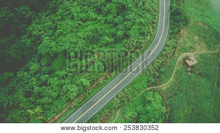 Aerial Top View Of Sky Road Over Top Of Mountain With Fog And Green Jungle After Raining In Morning