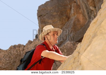 Man Climbing On Rock