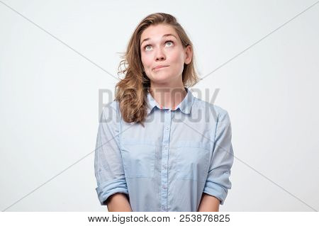 Close Up Portrait Of Pretty Confident Thoughtful Girl Looking Like Conspirator Standing Over Grey Ba