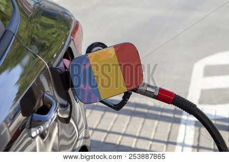 Fueling Car With Petrol Pump At A Gas Station.
