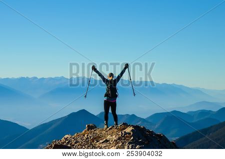 Woman Celebrating Reaching A Mountain Summit Whiler Hiking