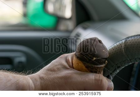Careless Driver Keeps Ice Cream Behind The Wheel Of The Car