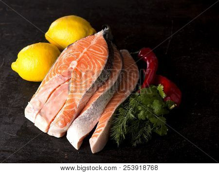 Raw Salmon Fish Fillet On Black Background
