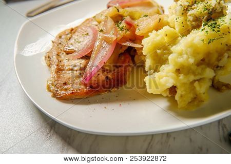Roasted Pork Chops With Applecider Sauce Sliced Apple Red Onions And Smashed Potatoes