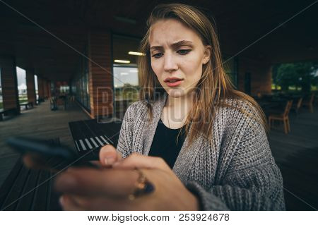 Sad Girl Feeling Upset Reading Bad News In Mobile Message On Smartphone At Home, Depressed Frustrate