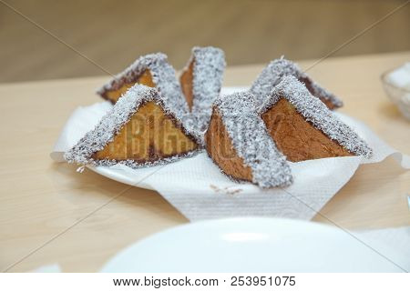 Three-pointed White Cake And Cake With Chocolate. Coconut Cake On White Plate. Cremeschnitte Cake On