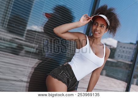 Young Woman In Visor Free Style On The Street Walking Near Windo