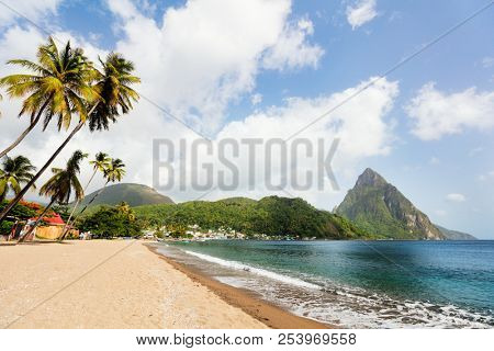 Idyllic white sand tropical beach with view to Piton mountains in Saint Lucia Caribbean