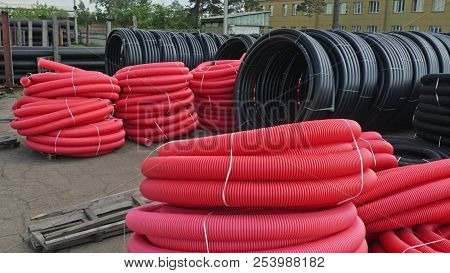 Warehouse Of Finished Plastic Pipes Industrial Outdoors Storage Site. Manufacture Of Plastic Water P