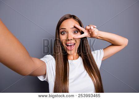 Self-portrait Of Brown-haired Gorgeous Attractive Nice Smiling Young Lady Over Grey Background, Show