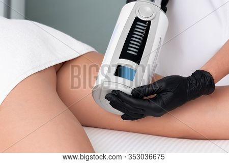 Cosmetologist In Rubber Gloves Doing Endospheres Therapy On Female Hips