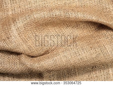 Crumpled Burlap Textile, Close Up View. Brown Burlap Fabric, Abstract Background. Texture Of Hopsack