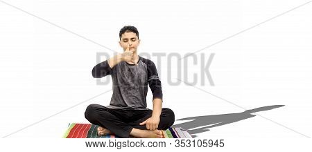 Full Body Shot Of Male Teenager Doing Nadi Shdhana Pranayama Or Alternate Nostril Breathing Isolated