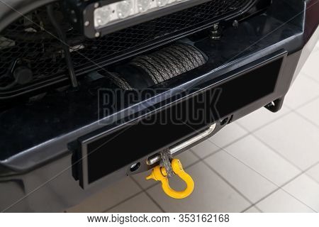 A Towing Winch With A Shackle And A Loop On A Metal Cable Mounted On A Car For Pulling Out And Evacu