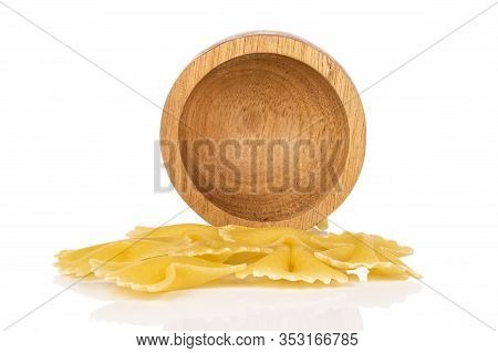 Lot Of Whole Yellow Pasta Farfalle In Bamboo Bowl Isolated On White Background