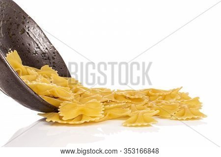 Lot Of Whole Uncooked Yellow Pasta Farfalle In Glazed Bowl Isolated On White Background