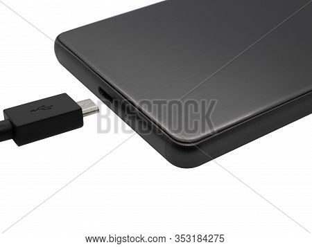 Micro Usb Cable And A Phone With Micro Usb Port On White Background. Cable For Charging And Data Tra