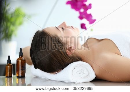 Girl Lies In Massage Parlor, Near Aromatic Oils. Way To Improve Your Health And Well-being. Effectiv
