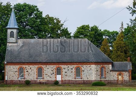 An Old 18th-century Church Built Of Stones In The Small Town Of Kaltene In Latvia.