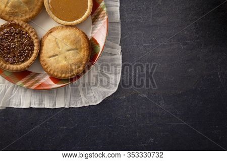 Holiday Table Set With Various Flavors Of Fresh Baked Pies