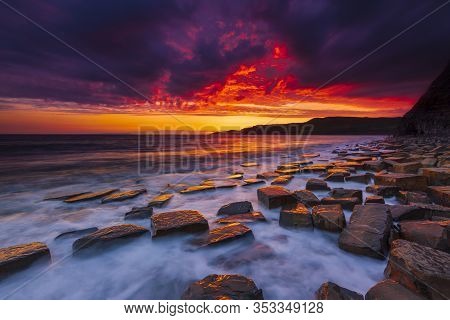 The Sky Clears After A Rain Storm Just Long Enough To Show The Deep Red And Purple Clouds Over The S