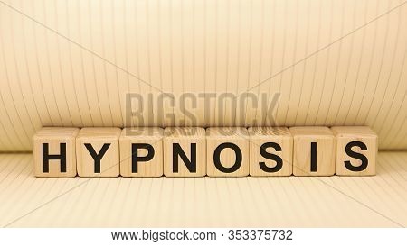 Word Hypnosis On Wooden Cubes On A Notebook Background