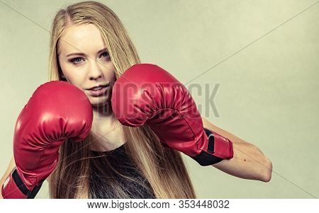Bloned Long Hair Girl Boxer In Big Fun Red Gloves Playing Sports Boxing. Female Fight For Equal Righ