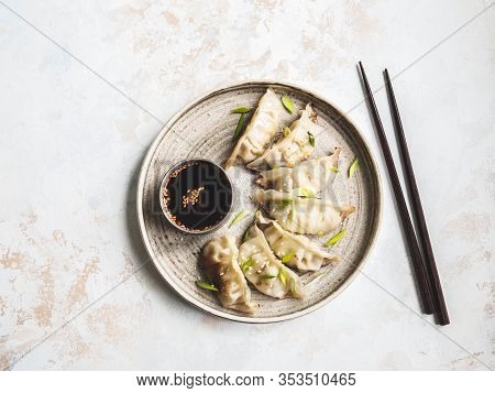 Chinese Traditional Dumplings - Gyoza With Pork And Vegetables On A Round Plate With Soy Sauce In A 