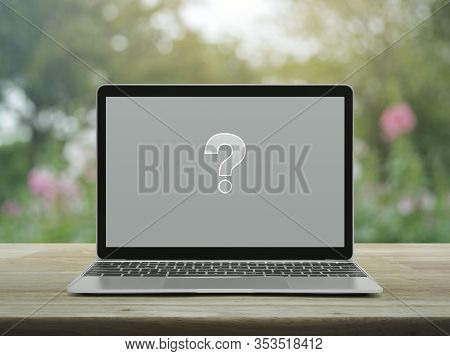 Question Mark Sign Flat Icon With Modern Laptop Computer On Wooden Table Over Blur Pink Flower And T